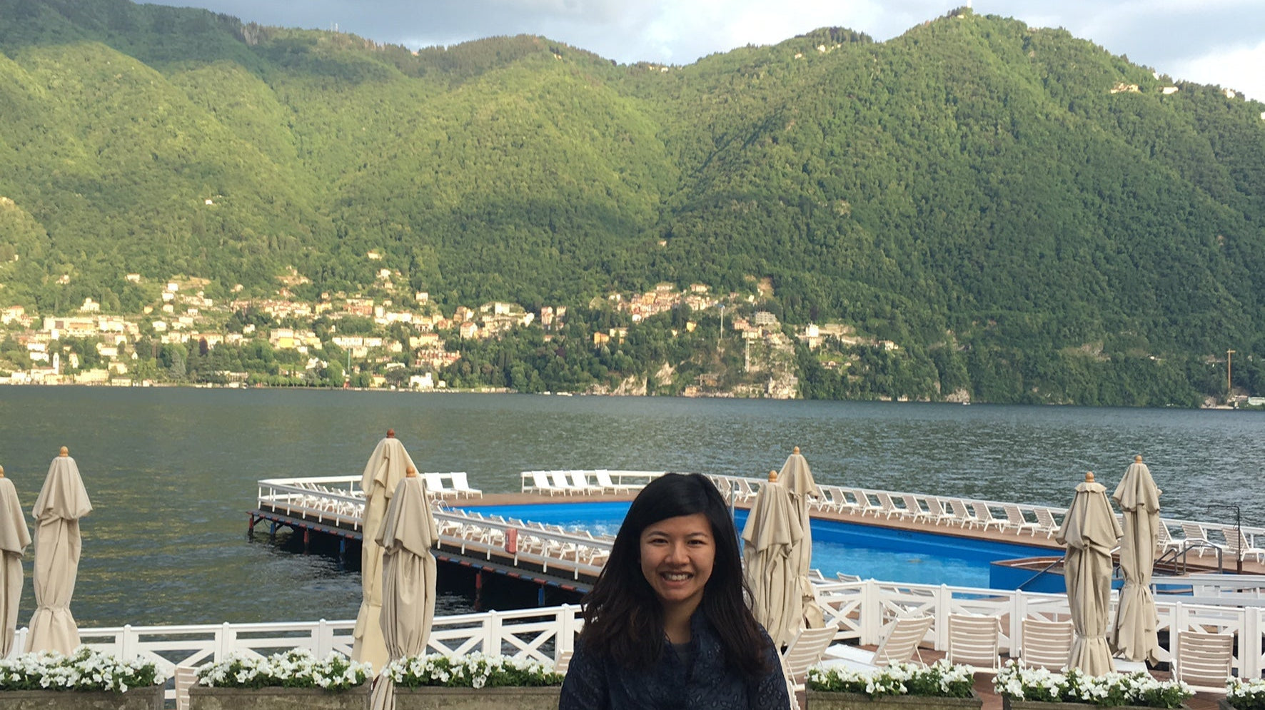 Artist Kirby stands in front of a harbour