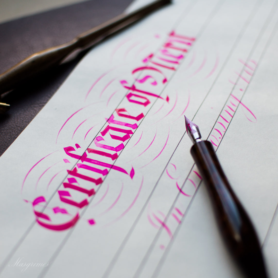 Pink ink calligraphy that reads "certificate" with a dip pen posed on top