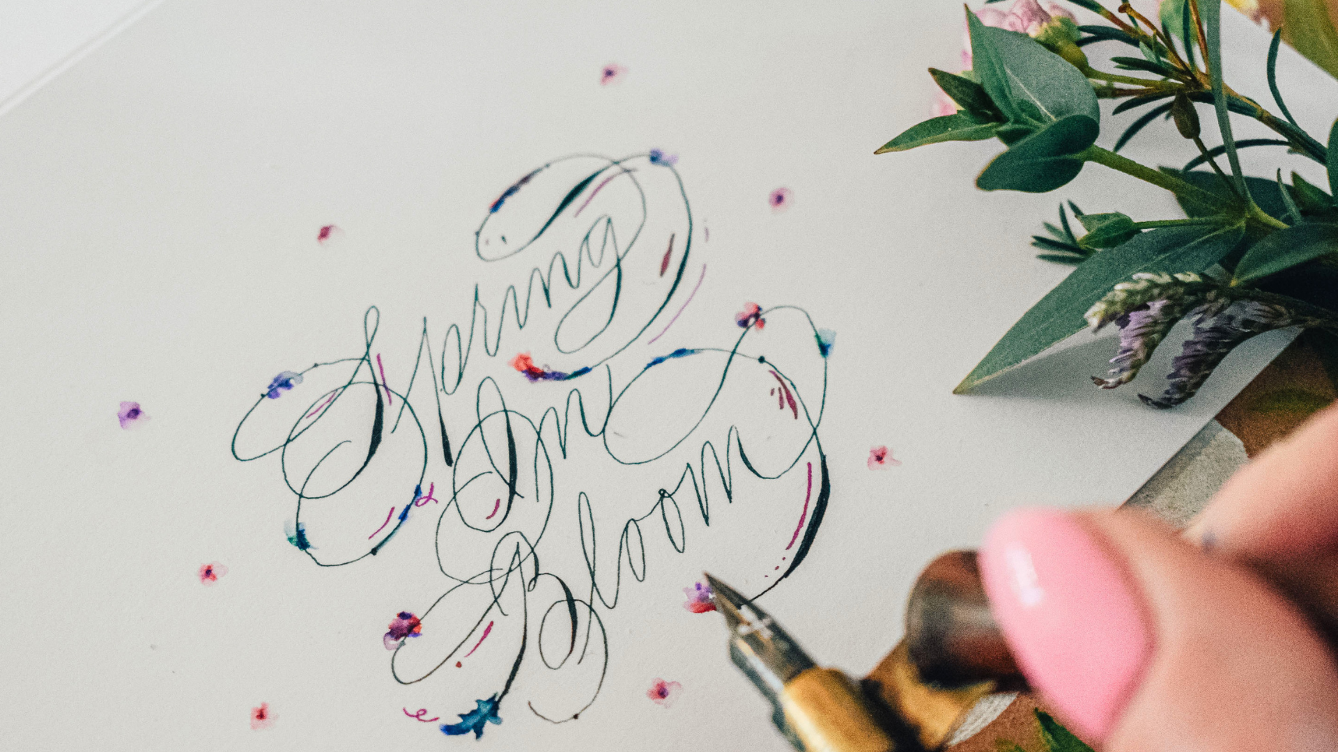 Calligraphy reads "spring in bloom" with the EF Principal nib beside it