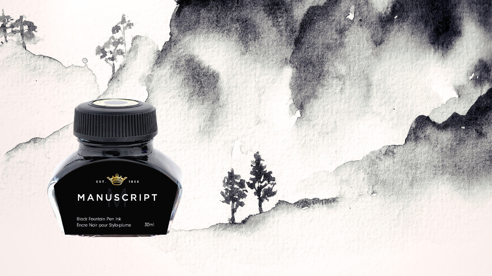 A bottle of black fountain pen ink sits on top of an illustration of mountains, painted in black ink on white paper