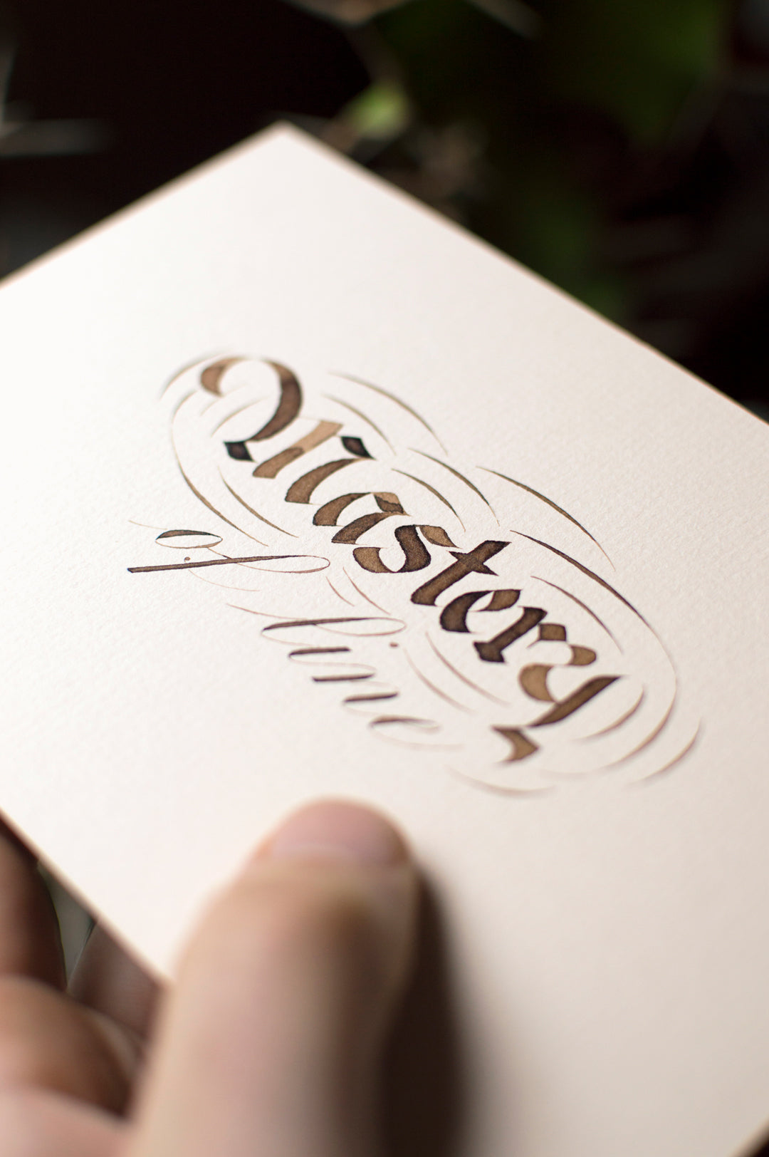 A bright red Hedley range Manuscript fountain pen lays elegantly on top of a black notebook.